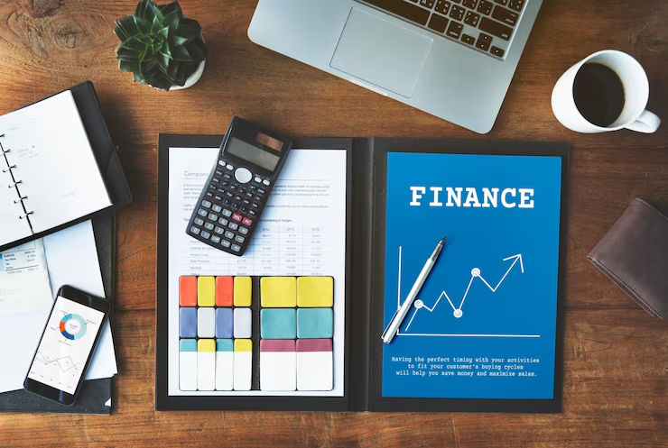 Finance planning materials with a calculator and financial chart